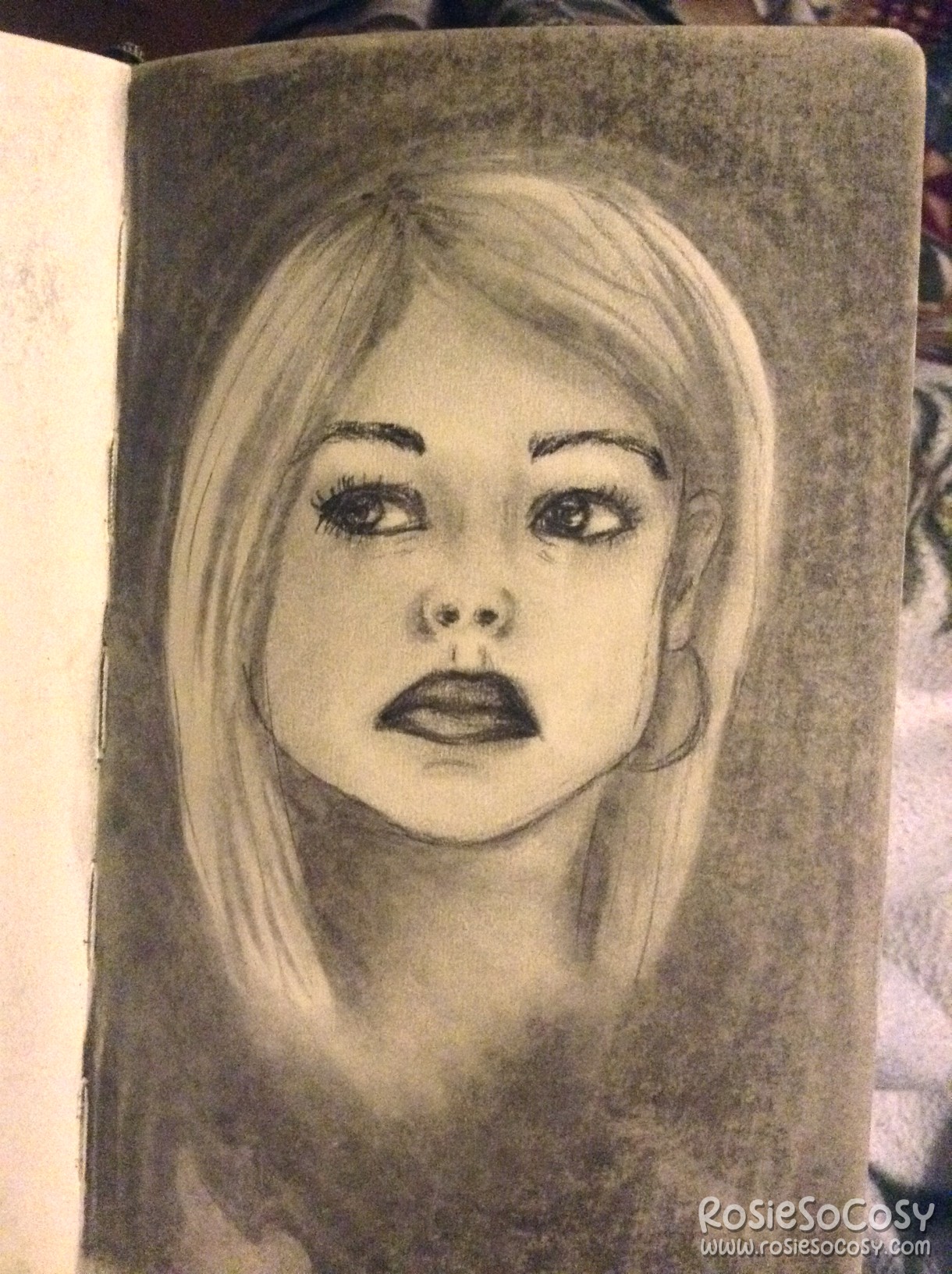 Charcoal drawing of Rose Tyler (portrayed by Billie Piper), the blonde companion to the 9th and 10th Doctor in Doctor Who. Rose is looking to the left. She has a serious look on her face. The corners of her mouth are pointing downwards. She has a hoop earring in her left ear. Her right ear isn't visible since the blonde, straight hair is in front of it. The background is black.