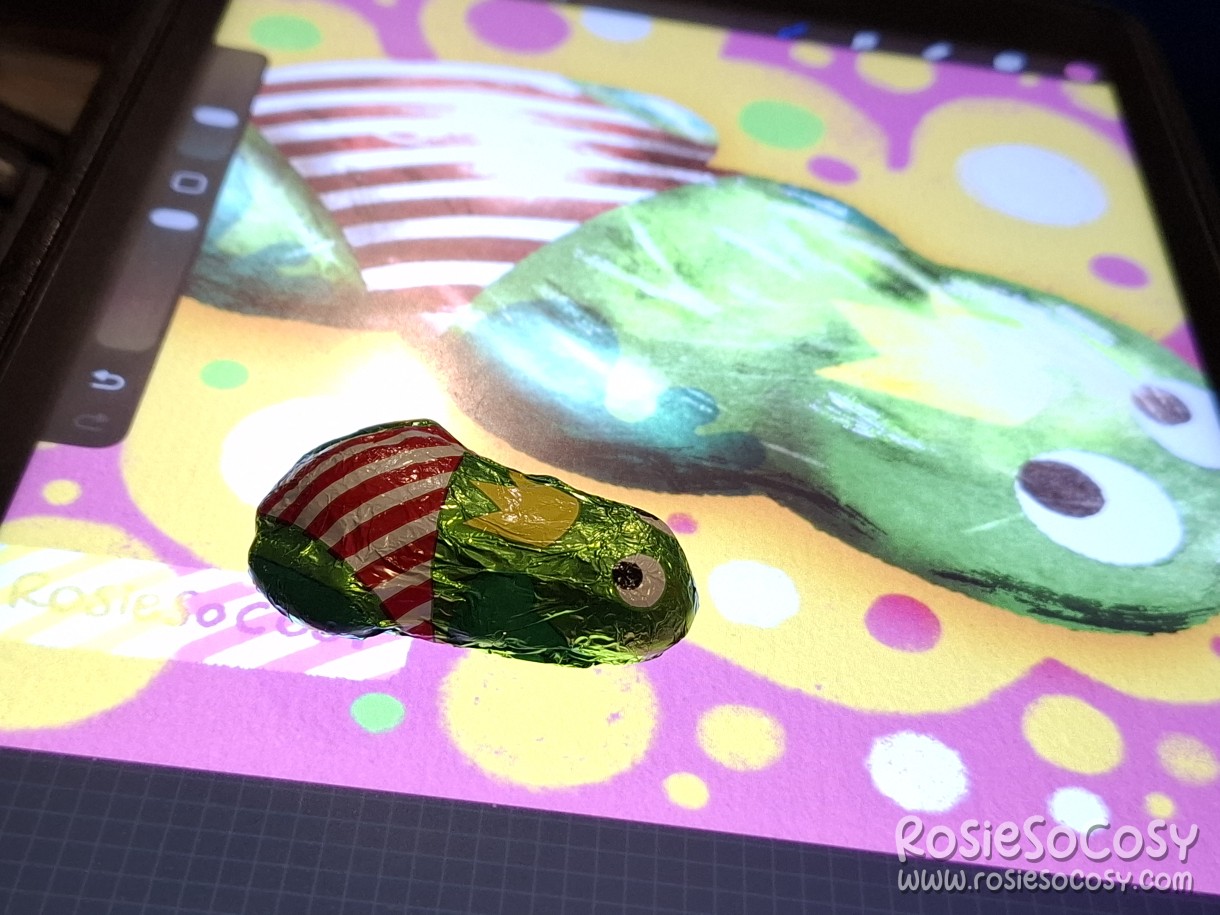 Reference photo of the chocolate froggy, next to my iPad with the drawing.